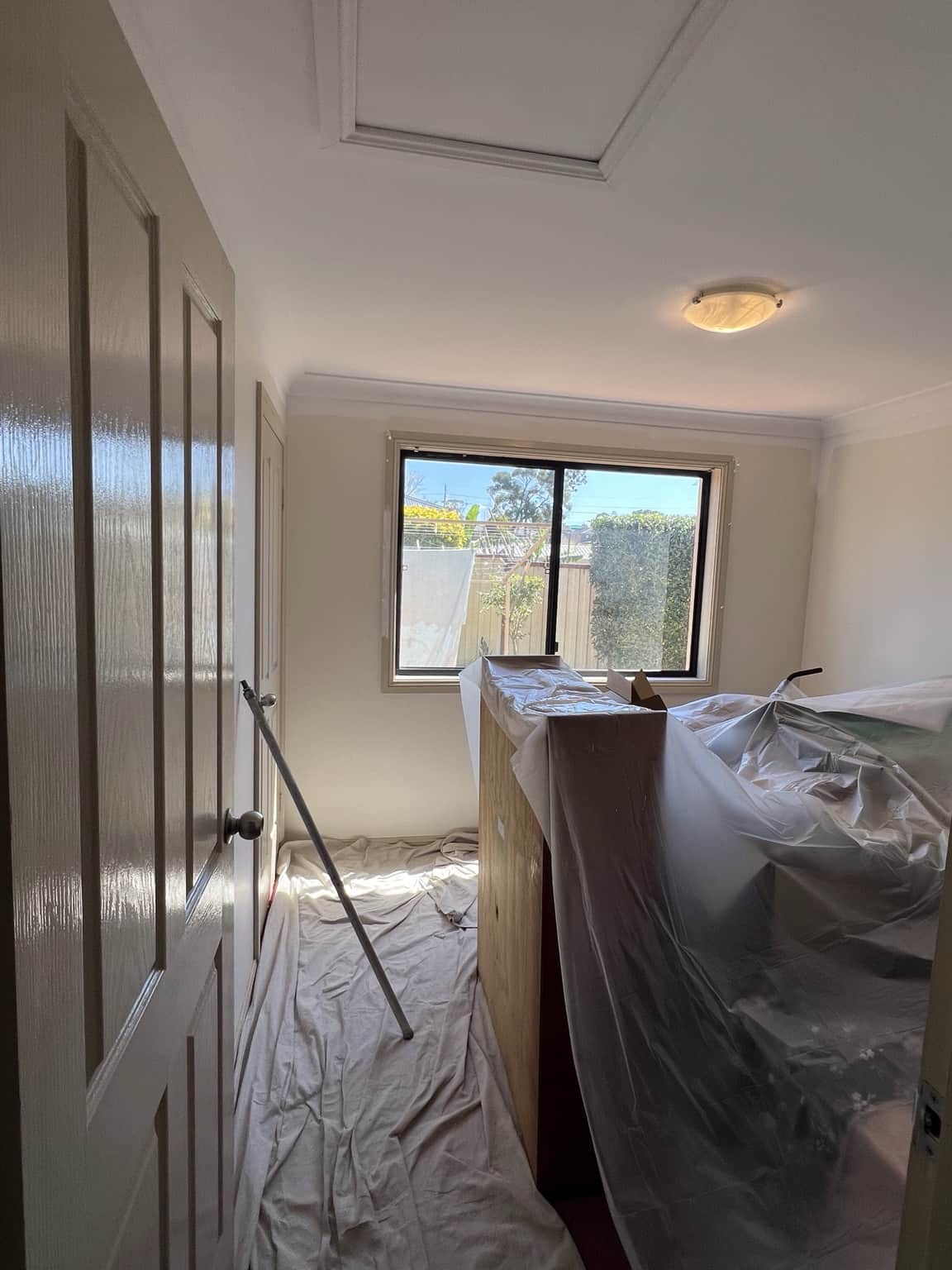 Bedroom protected and prepared before interior repainting in Merrylands