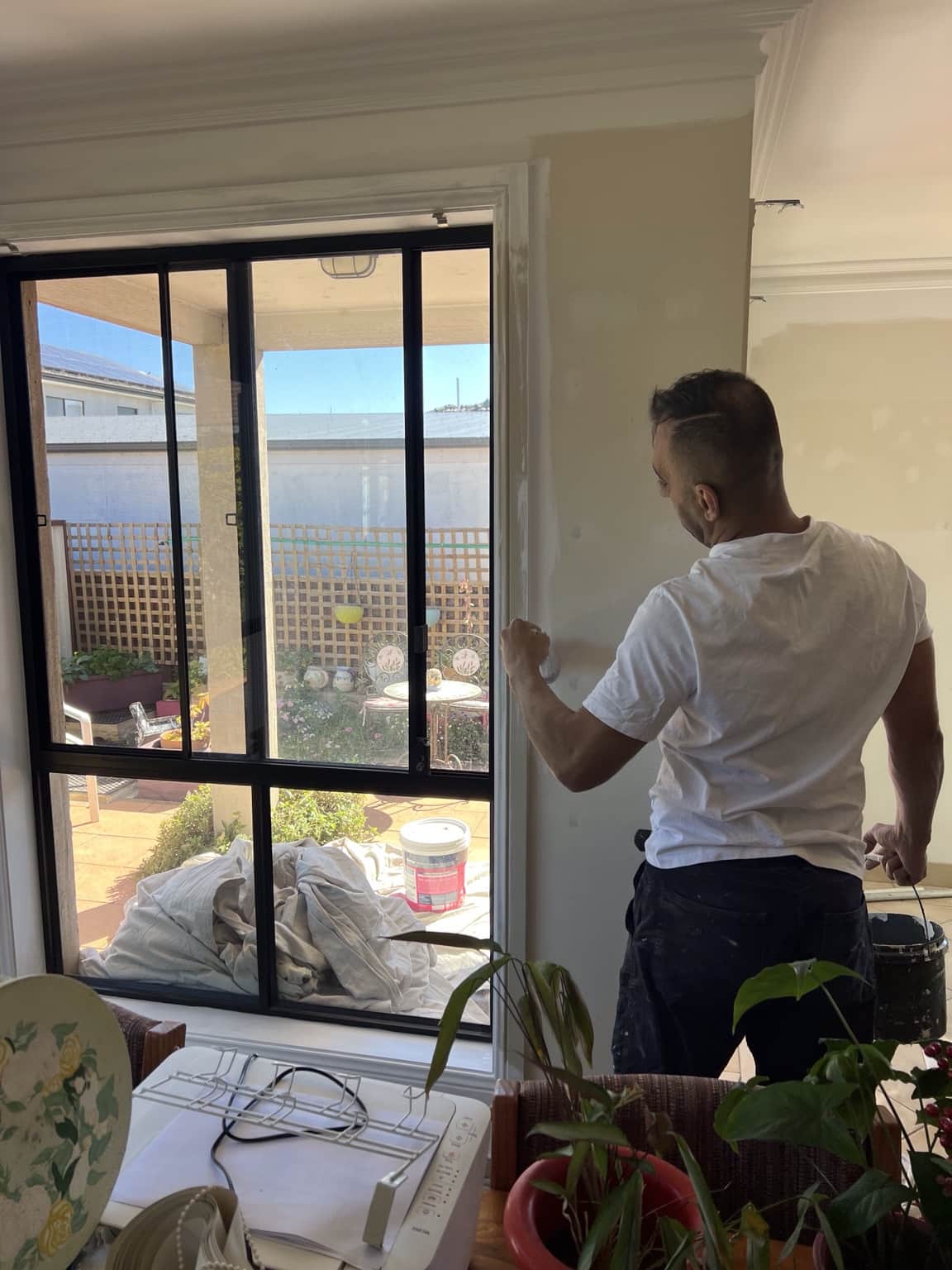 Painter preparing interior walls during a house repaint in Merrylands