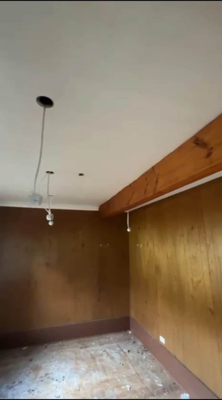 Timber-lined living room before interior restoration and painting in Baulkham Hills