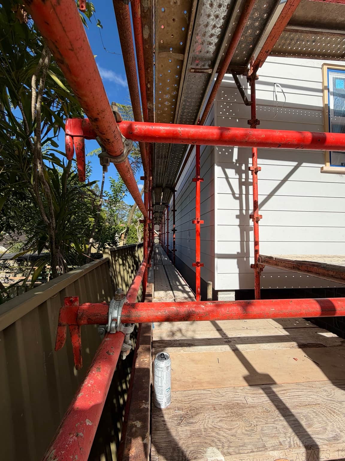 Scaffolding beside the weatherboard exterior during the Beecroft painting project