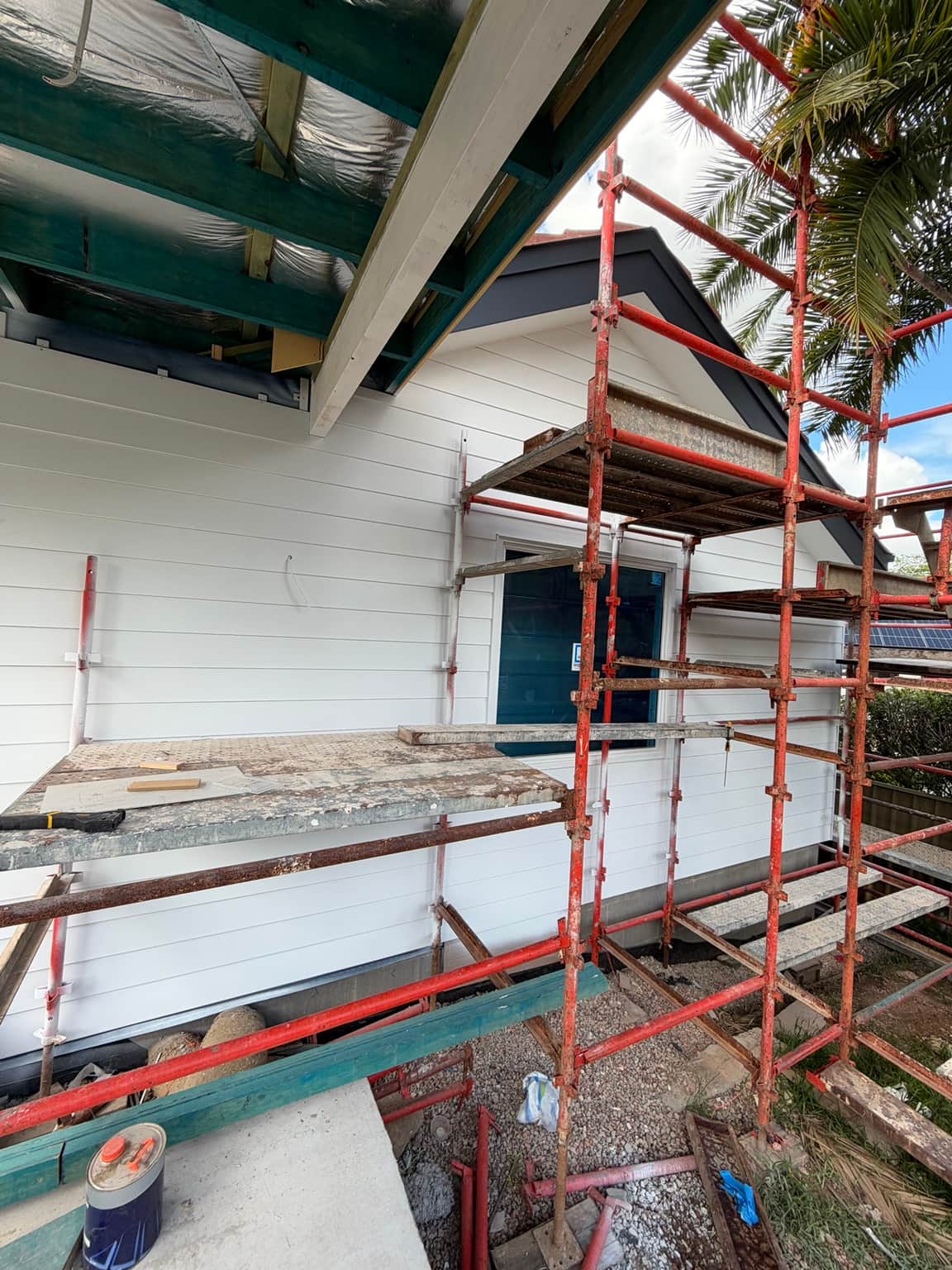 Rear elevation with light painted cladding and grey gable trim in Beecroft