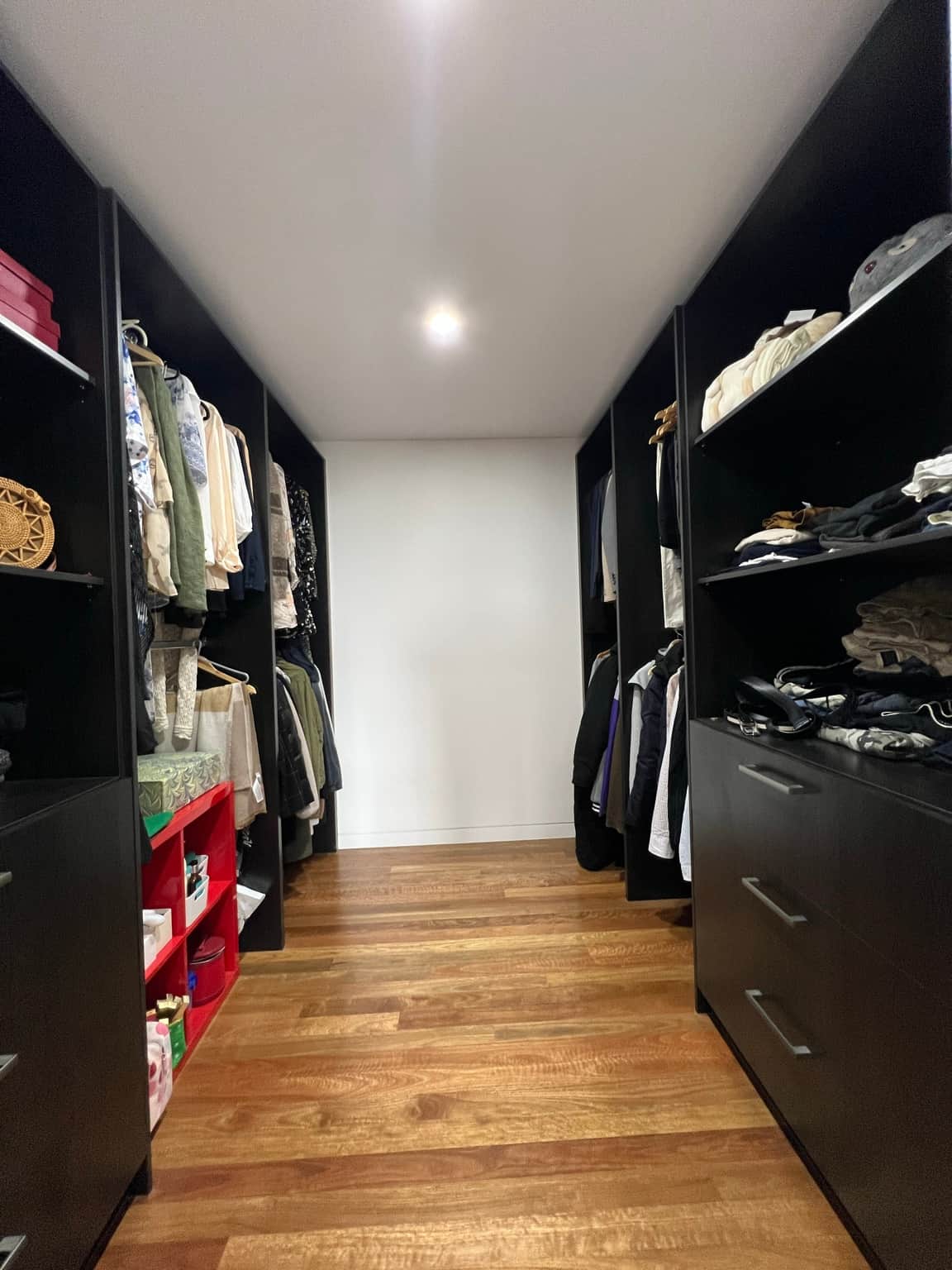 Walk-in wardrobe ceiling above dark fitted cabinetry