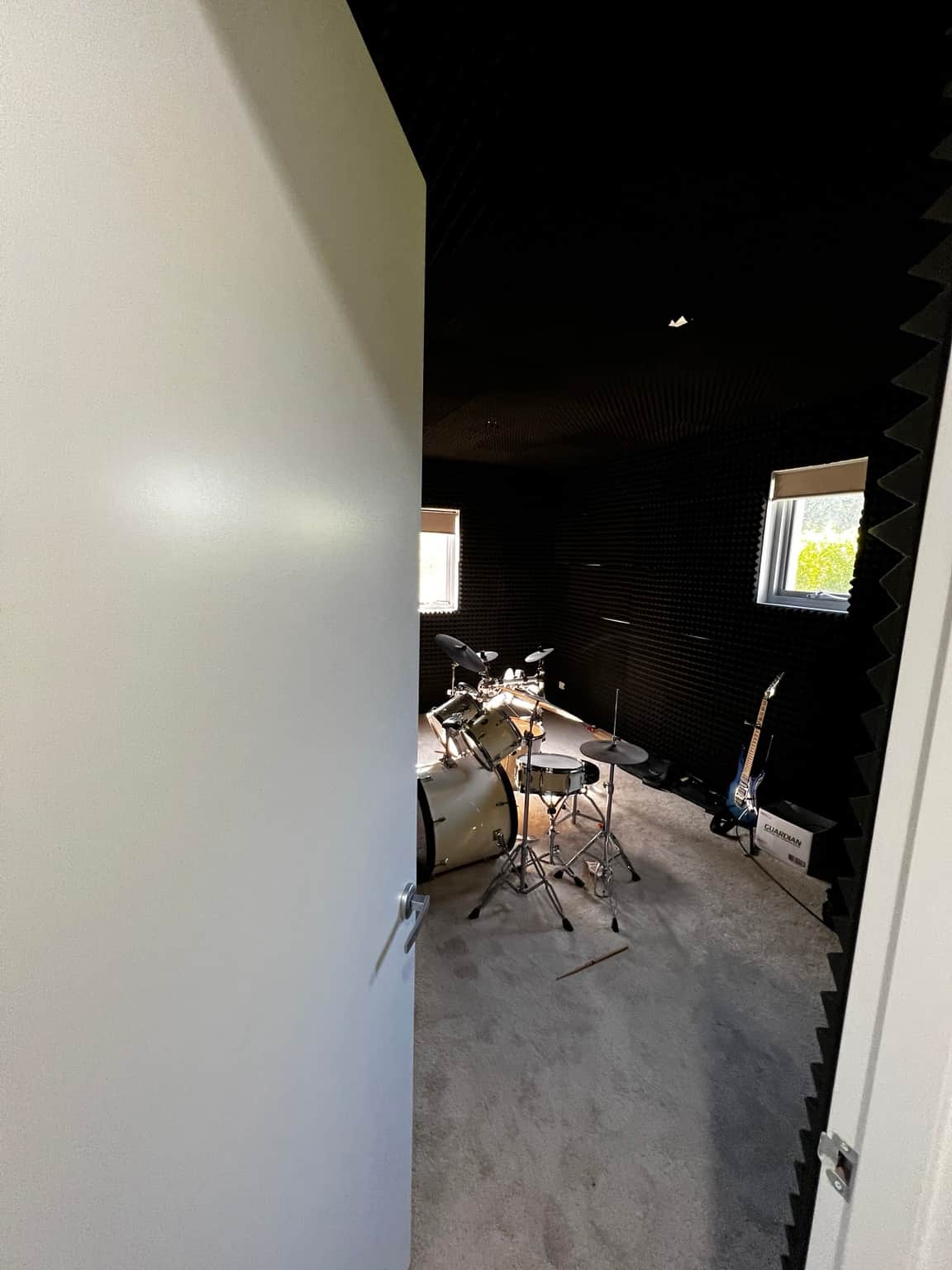 White painted door and frame at the entrance to a home music room