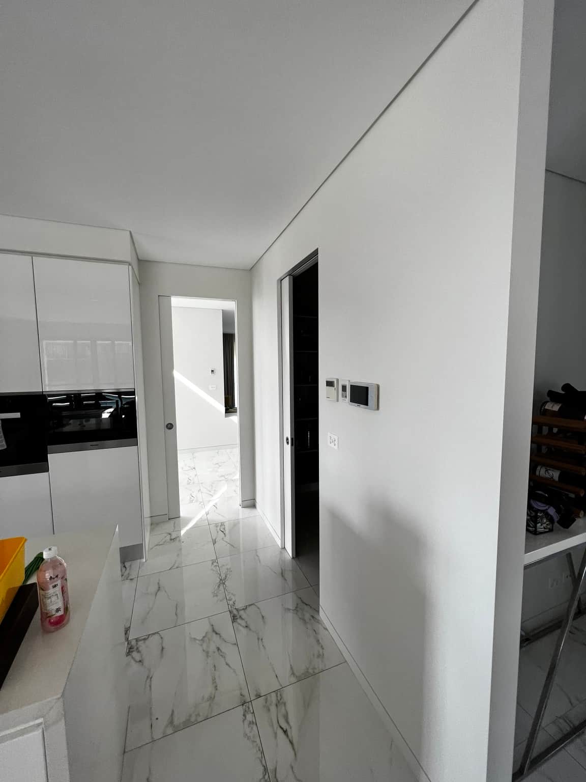 Kitchen entry with painted door frame and adjoining hallway walls