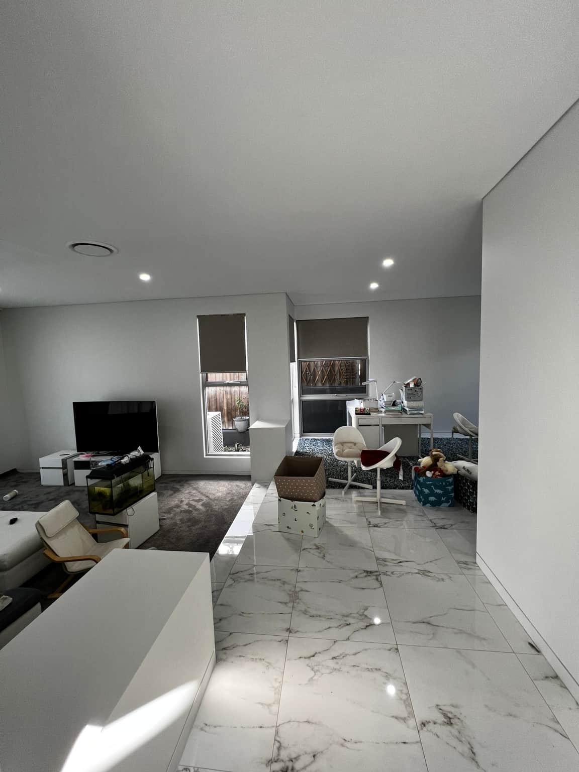 Wide view of painted living room walls and ceiling from the kitchen
