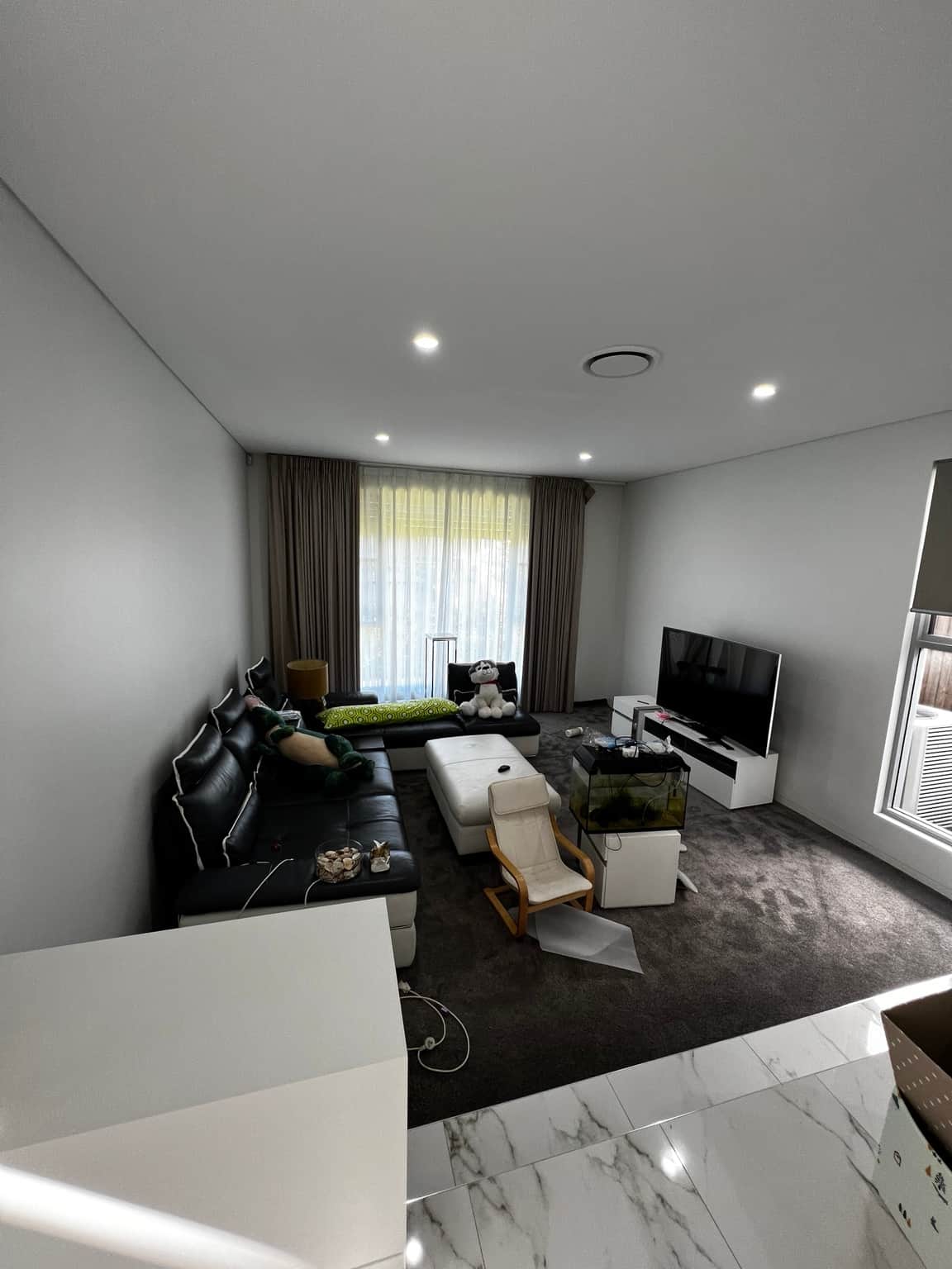 Family room with painted walls around the windows and television