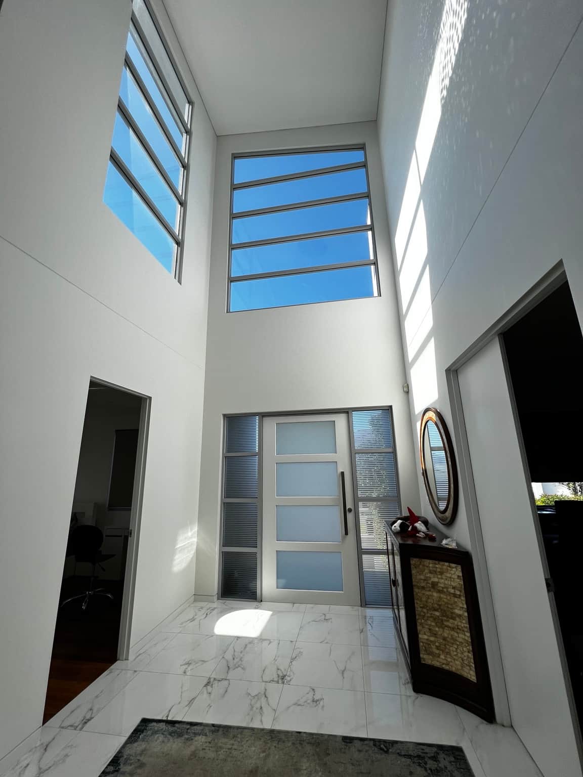 Tall entrance walls and high windows in the Bella Vista interior project