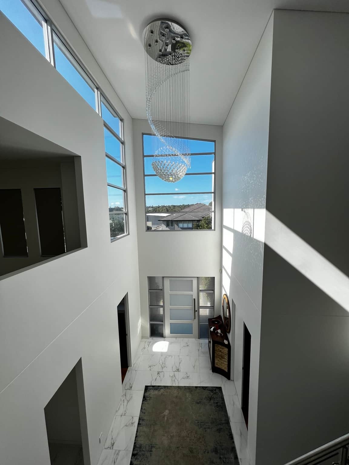Double-height entrance with painted walls around high windows in Bella Vista