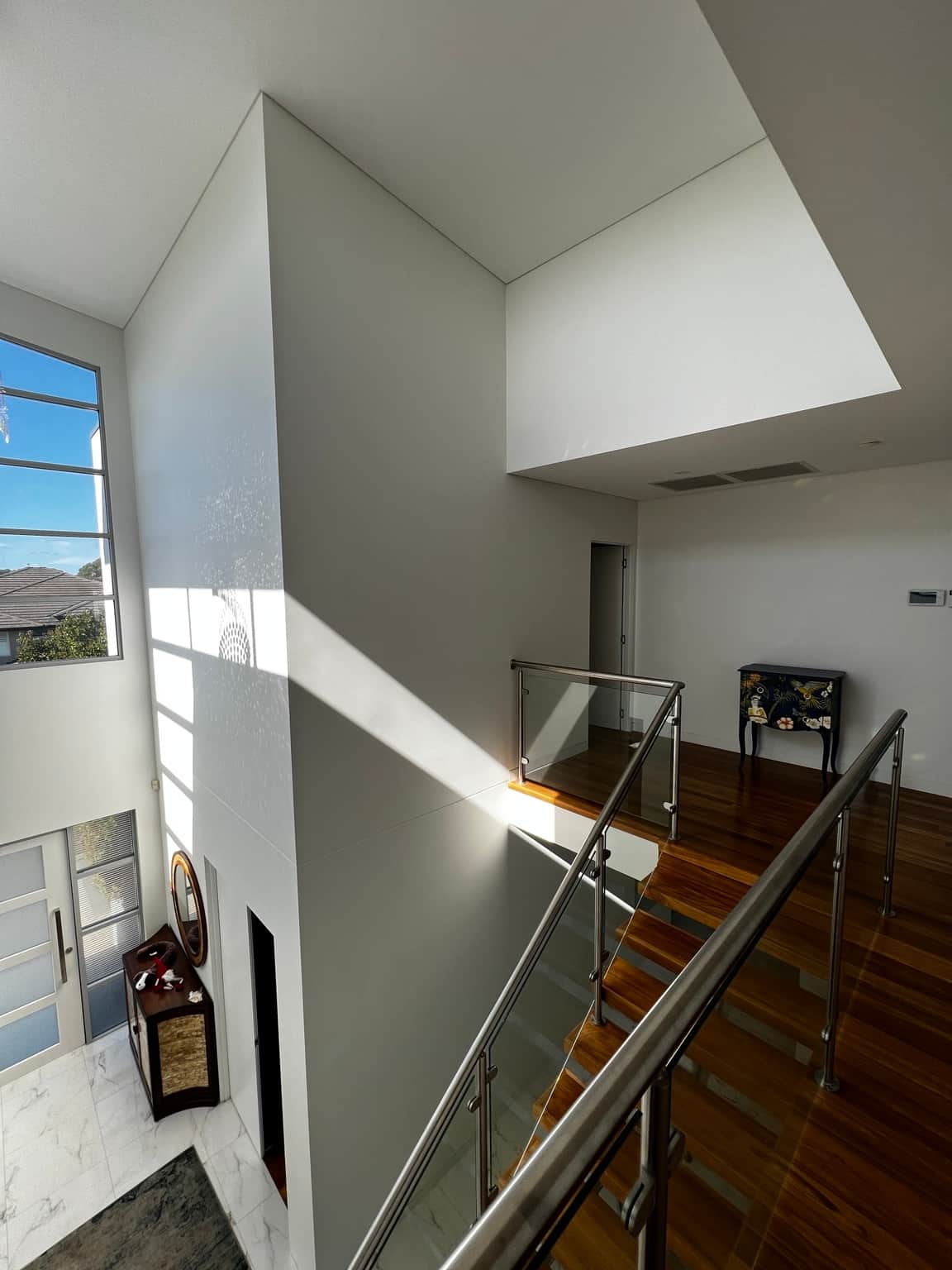 Upper landing and tall stairwell walls in a six-bedroom Bella Vista home