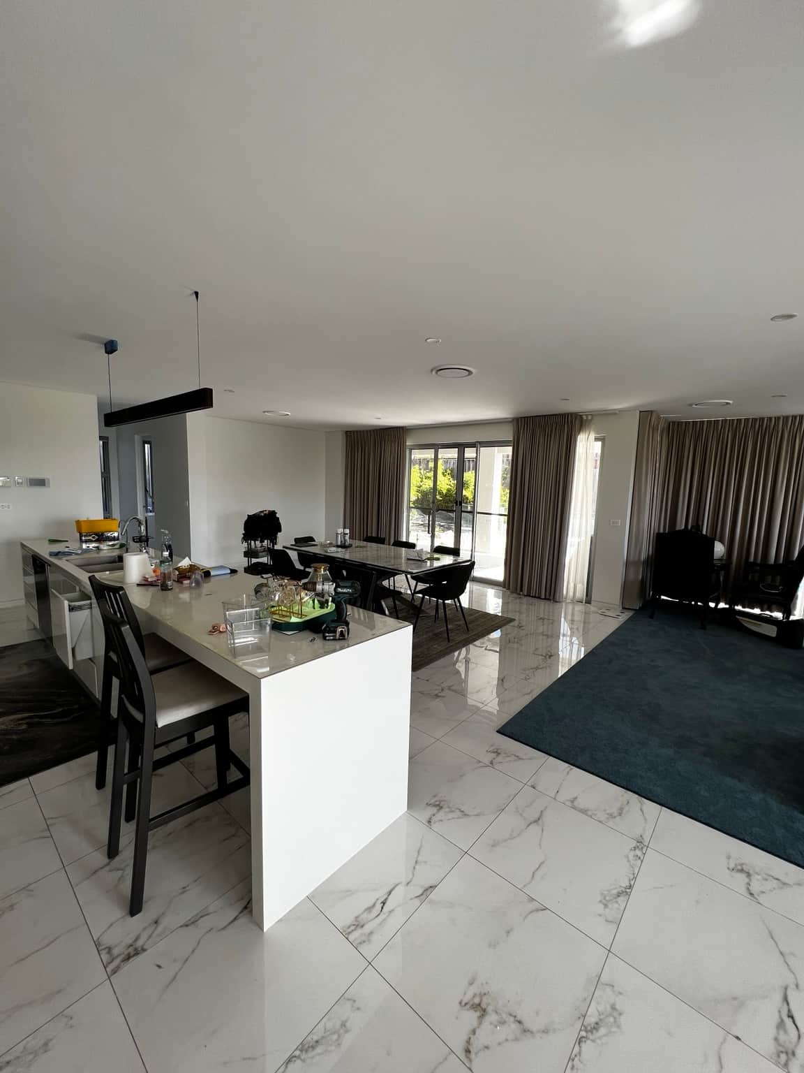 Open-plan kitchen and dining area with painted walls and ceiling in Bella Vista