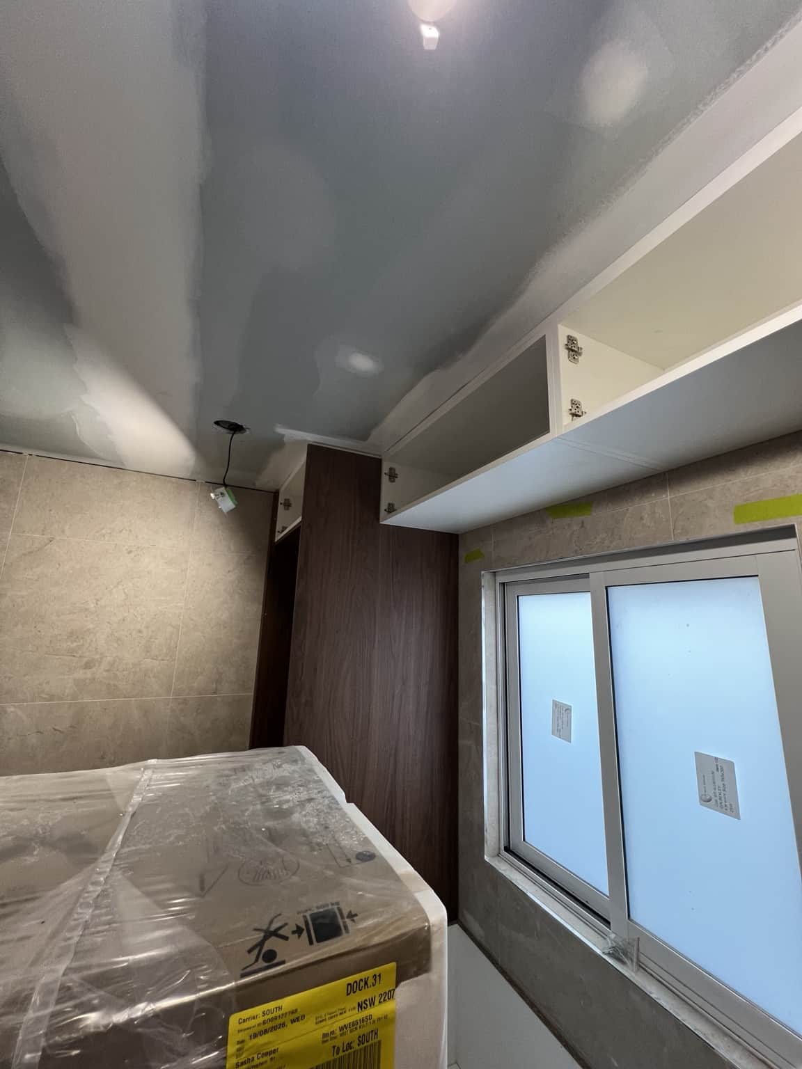 Prepared plasterboard ceiling above the bathroom window before painting in Bexley
