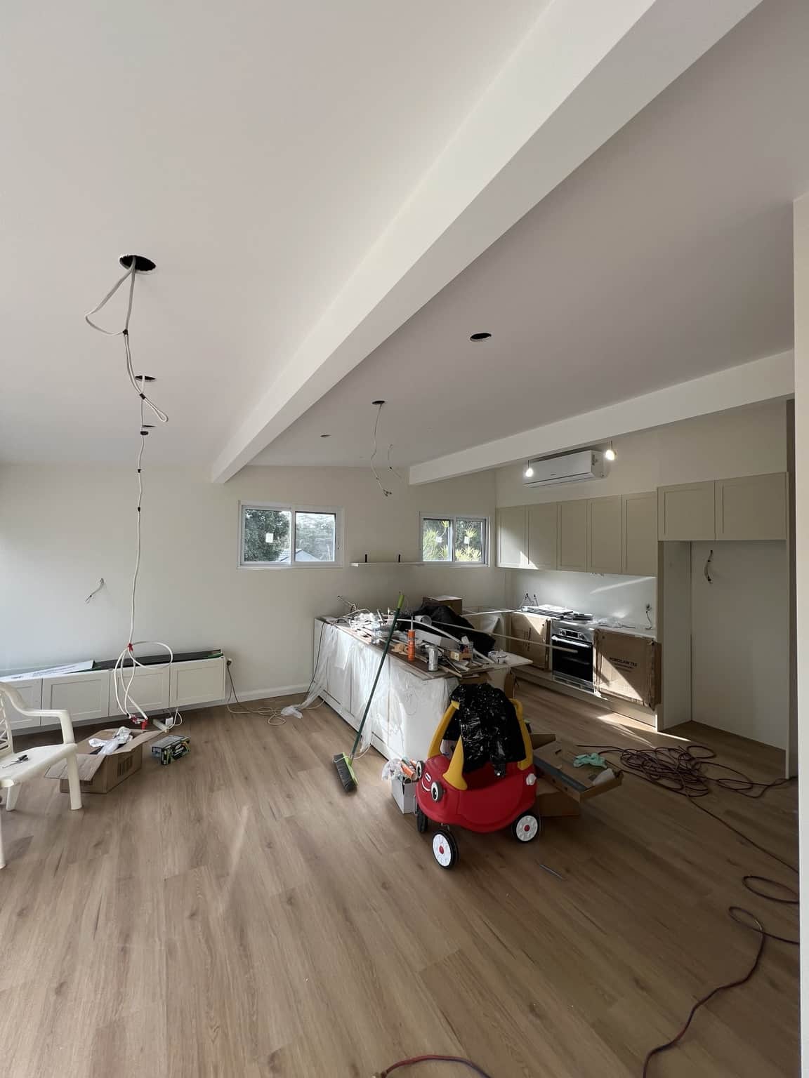 White painted ceiling beams and walls across the Bexley kitchen and living area