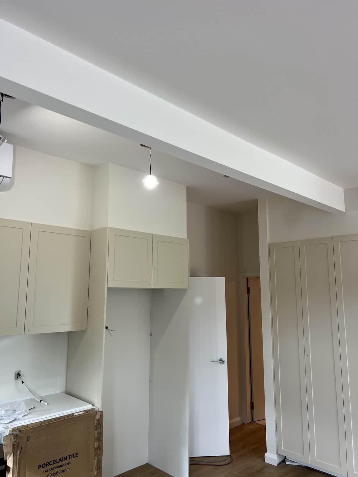 Painted kitchen walls, ceiling beam and timber doors in the Bexley home