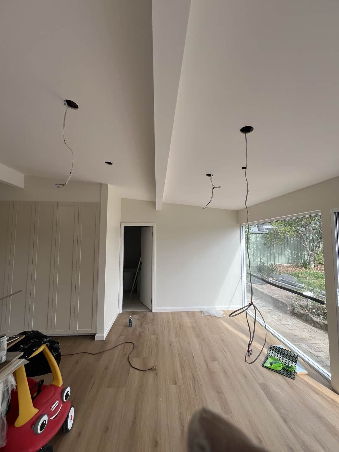 Finished white ceiling and beams beside the living room window in Bexley