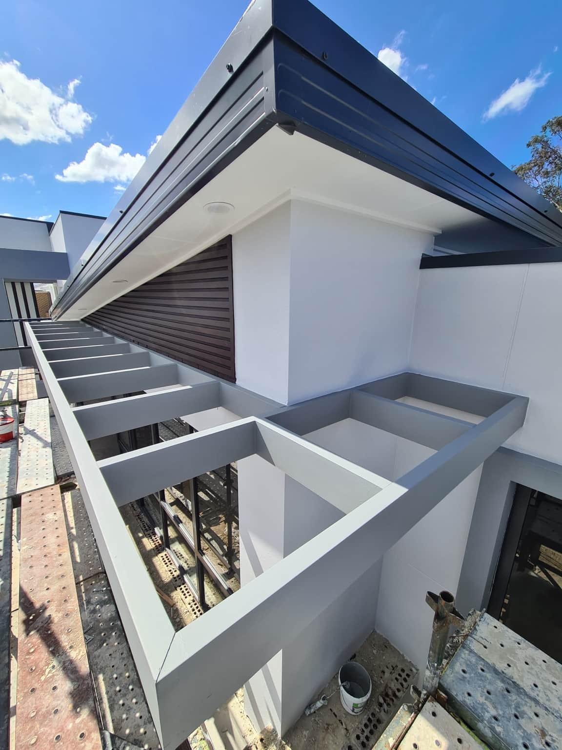 Light-coloured painted eaves and pergola-style beams on the new Box Hill home