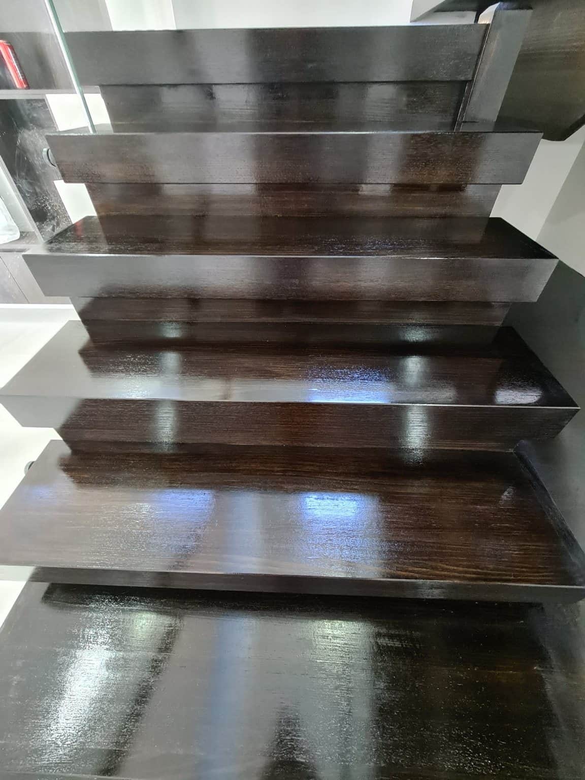 Close-up of dark timber stair treads in Box Hill, showing the wood grain beneath the Feast Watson clear coat.