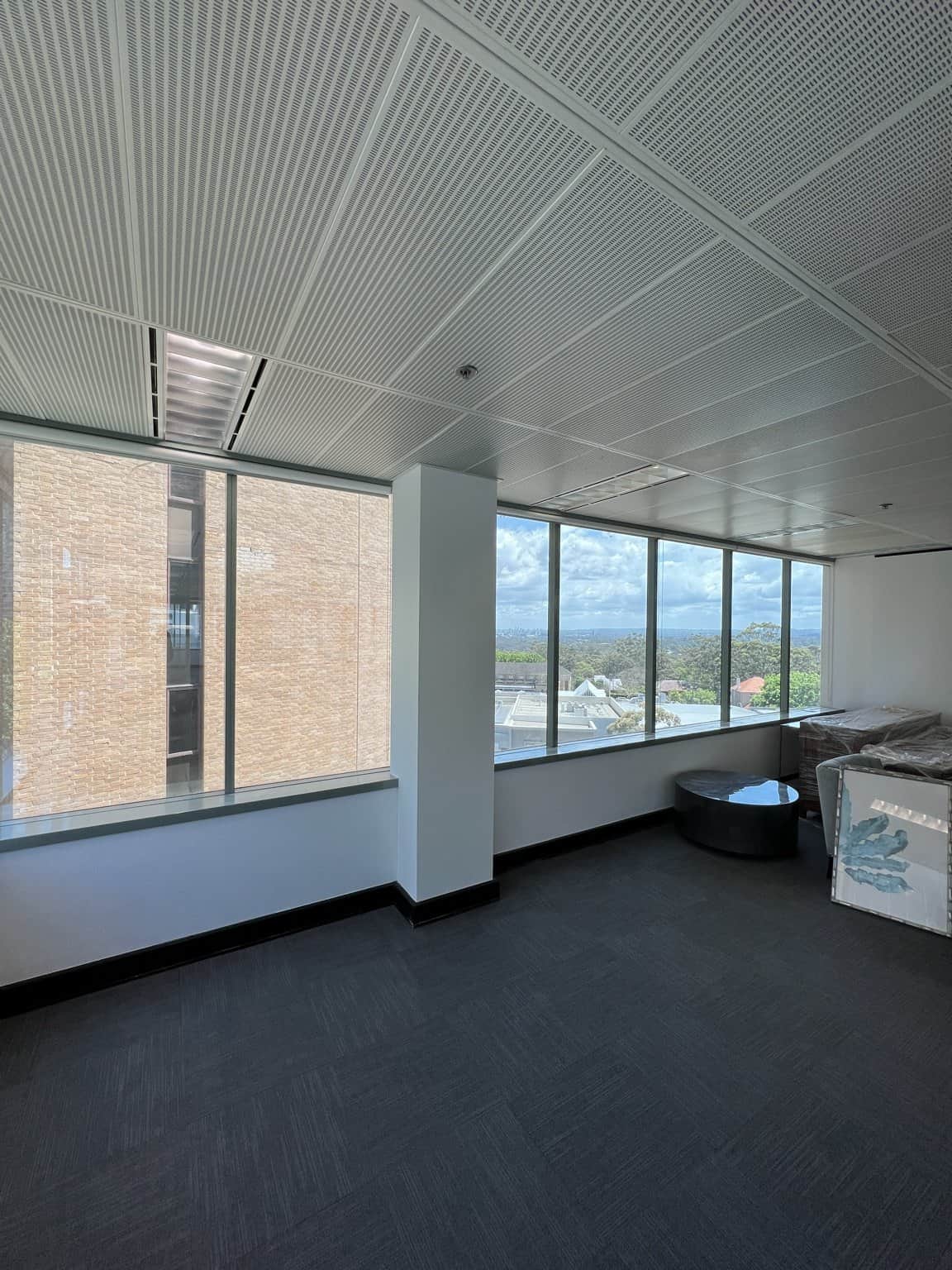 Light painted column between large windows in a Chatswood office.