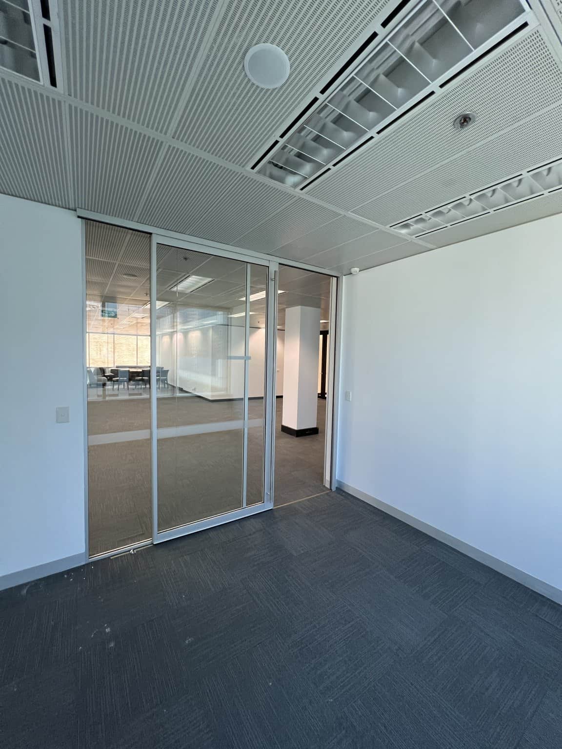 Light walls around a glass-partitioned meeting room in Chatswood.