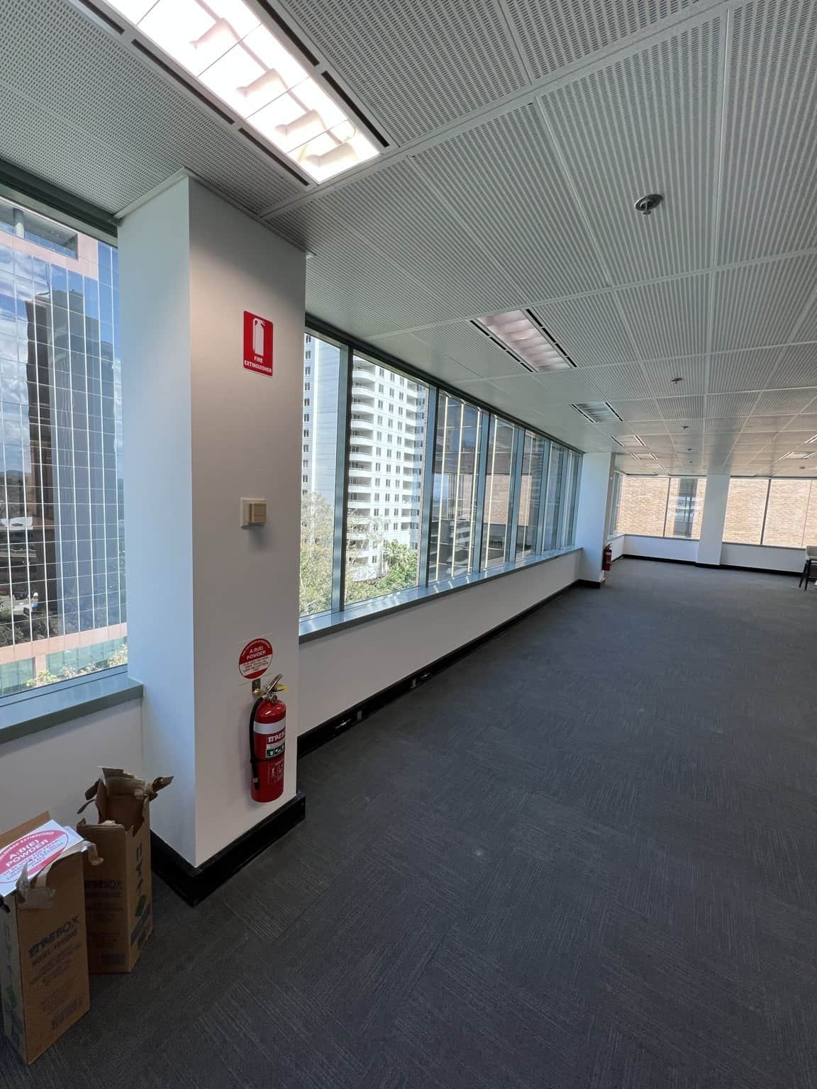 Chatswood office window wall and column beside a fire extinguisher.