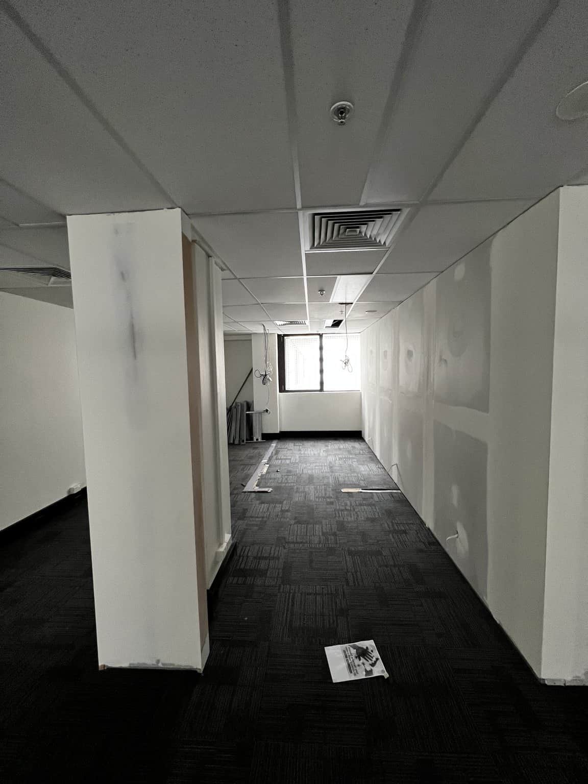 Chatswood office passage with a prepared column and partition wall.