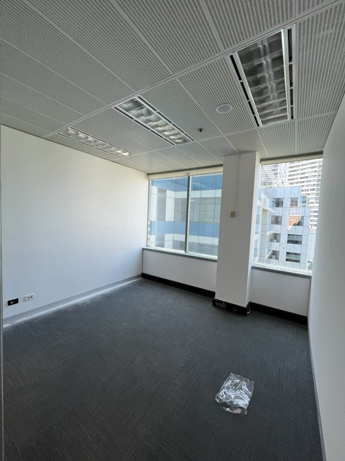 Chatswood private office with light painted walls, grey carpet and large windows.