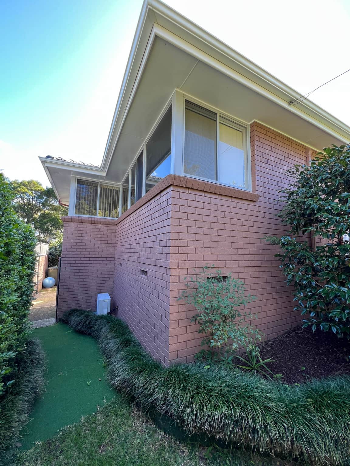 Corner elevation showing the finished brick and window painting in Cowan