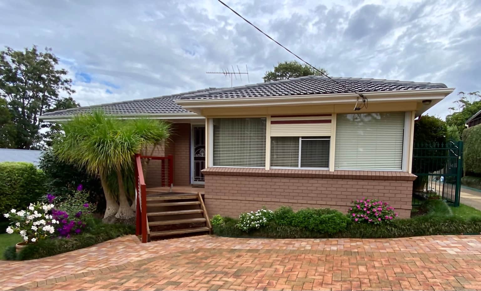 Painted brickwork and aluminium windows at the front of the Cowan home