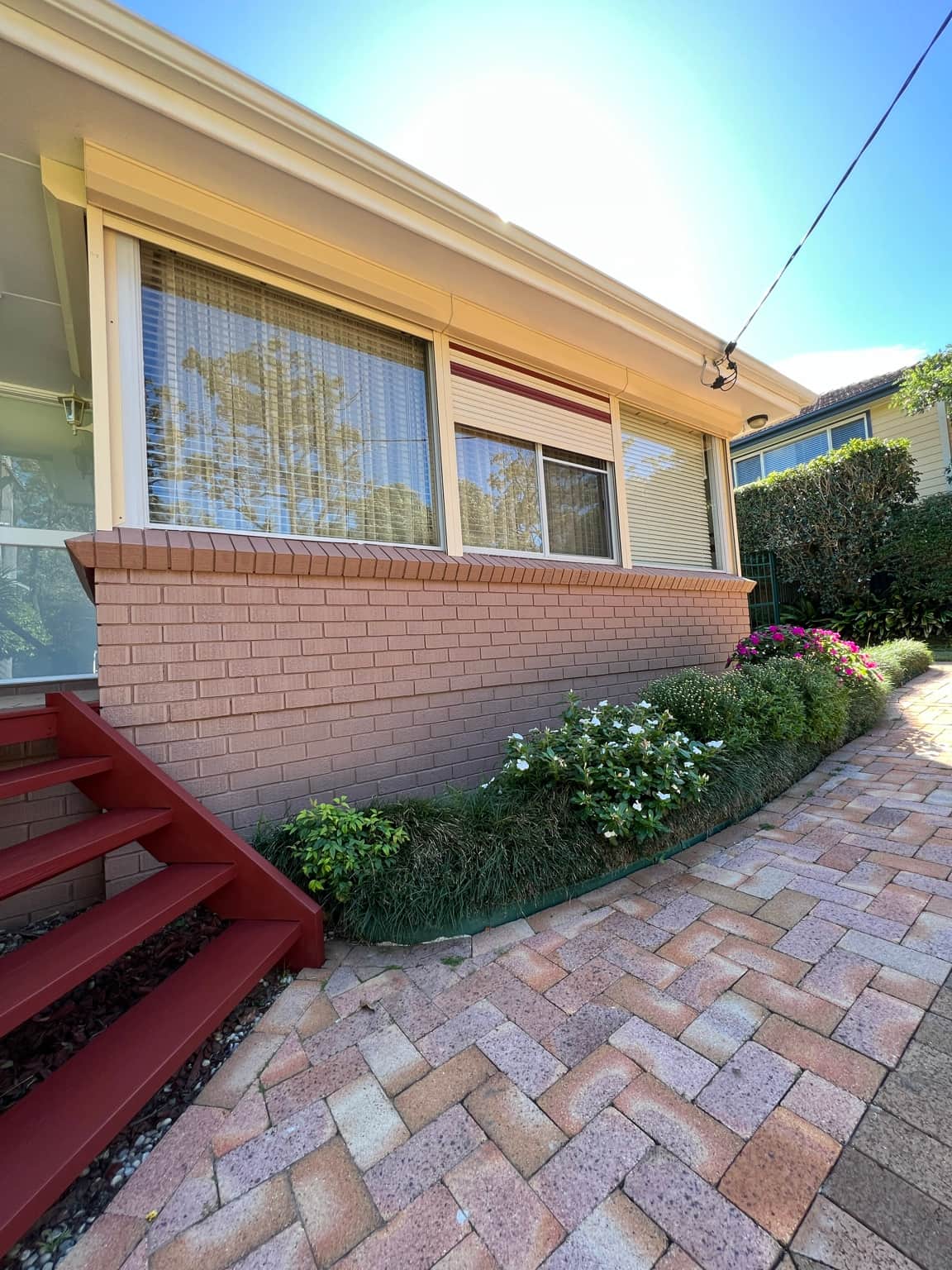 Cowan home entrance and painted brickwork beside the garden