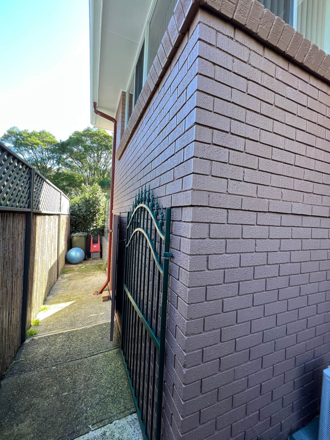 Side brick wall finished with Dulux Weathershield in Cowan