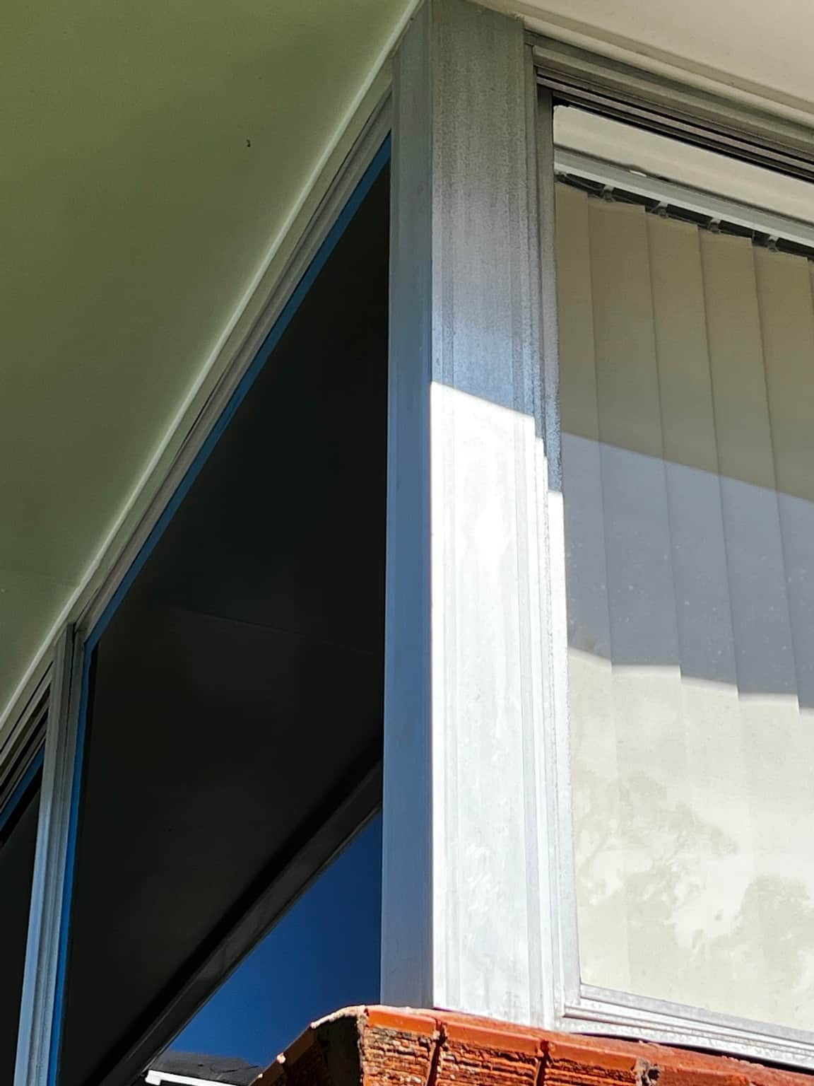 Corner aluminium window during the Cowan exterior painting project