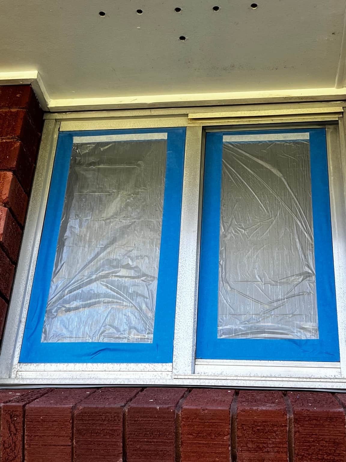 Aluminium window masked for spray painting in Cowan