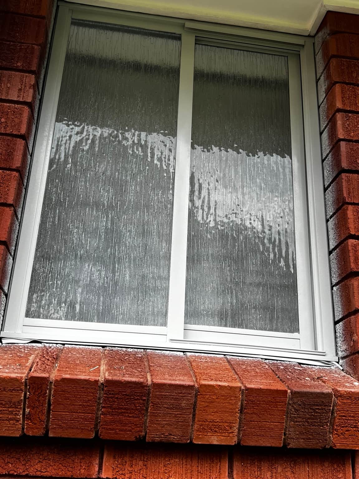 Aluminium window frame with obscure glass during the Cowan project