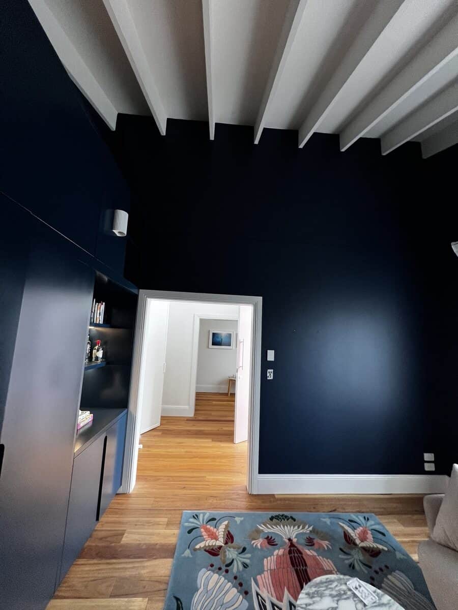 Dark blue interior walls with white exposed beam ceiling painted in Dover Heights