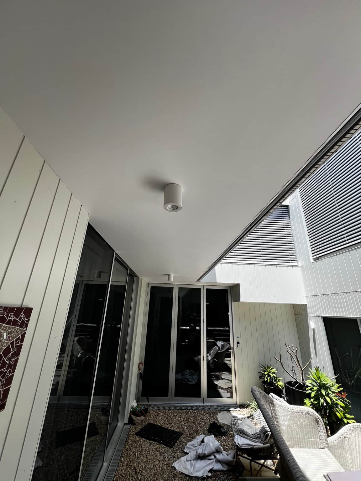 Wide view of the painted courtyard ceiling beside exterior glazing in Dover Heights