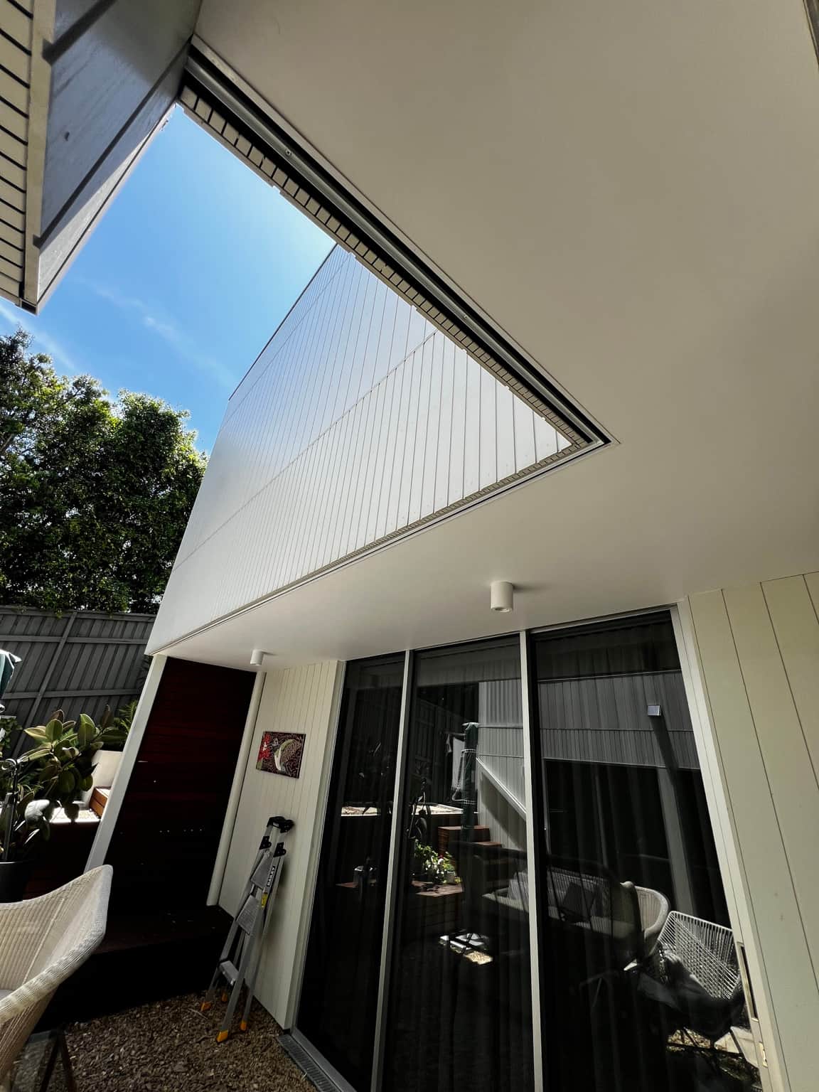 Courtyard eaves and light-coloured exterior cladding at a Dover Heights home