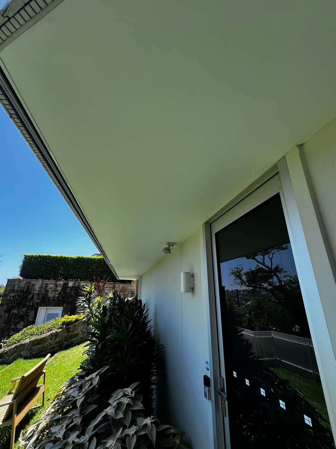 Side eaves and exterior wall beside garden planting at the Dover Heights project