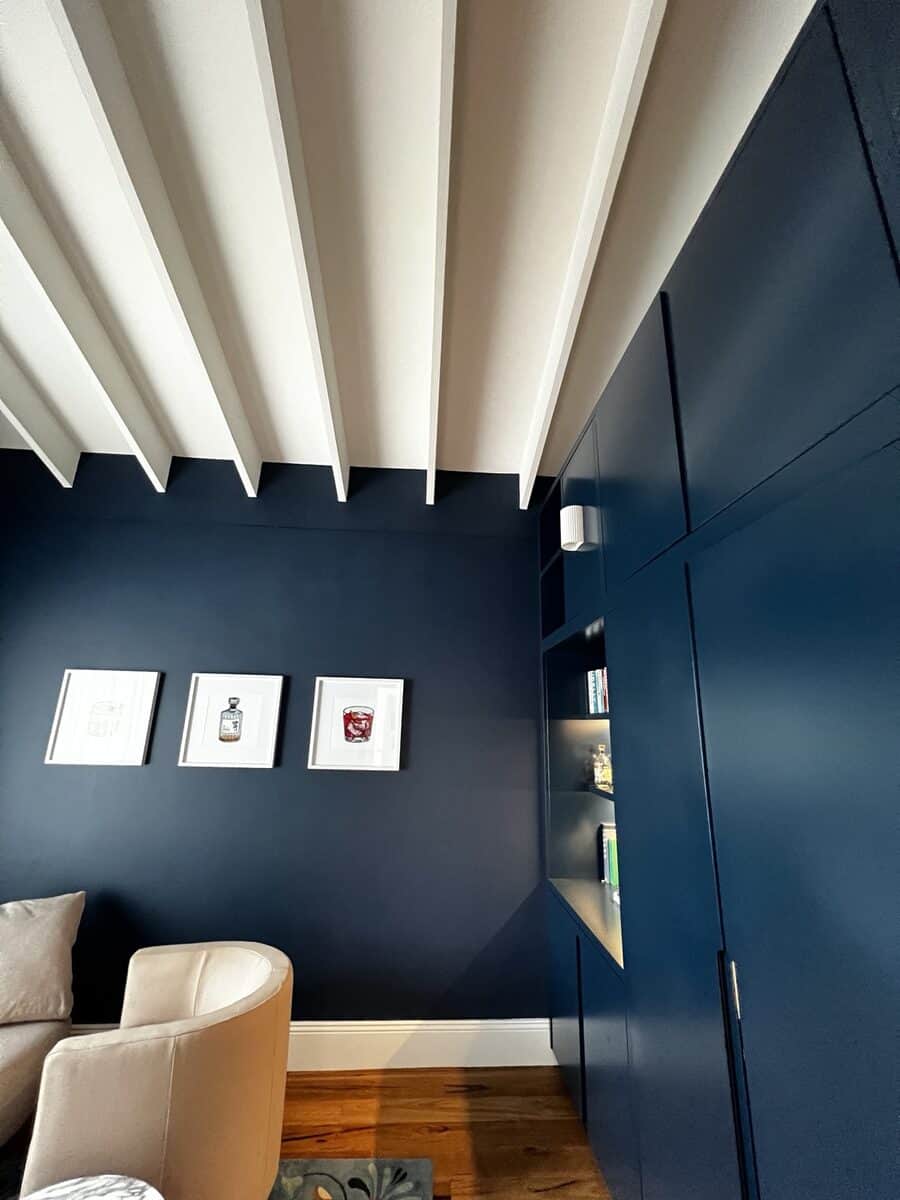 Dover Heights living room with dark painted walls and custom built-in cabinetry