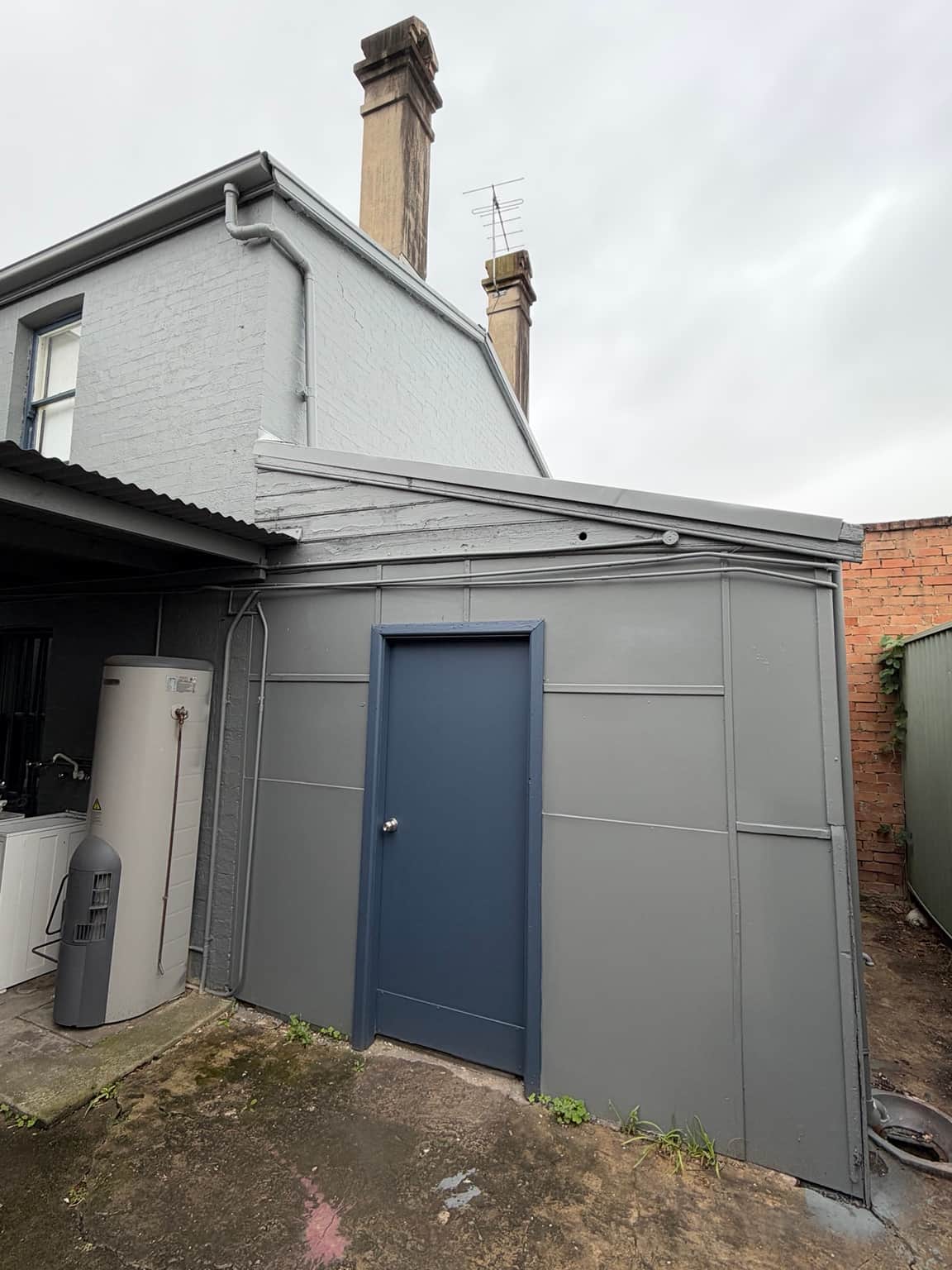 Grey rear extension and contrasting door after painting at the Granville property