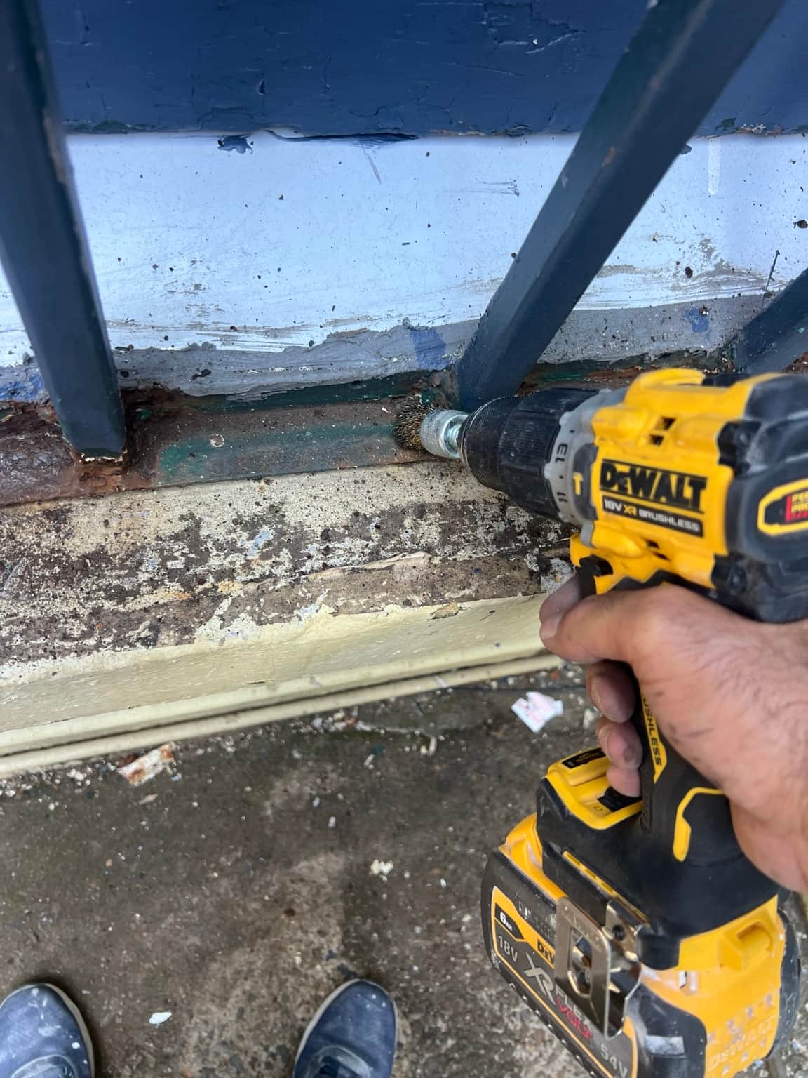 Power-tool sanding of metalwork during preparation for the Granville exterior repaint