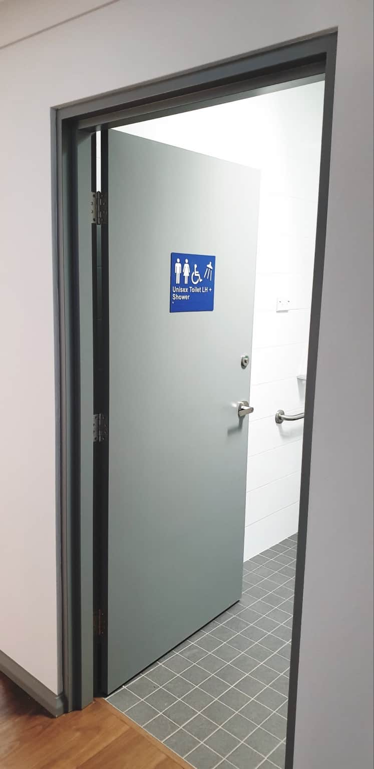 Grey painted accessible bathroom door and frame in Hornsby