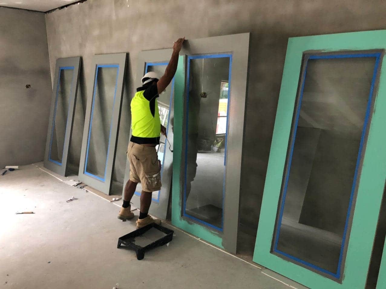 Door panels being painted during the new childcare project in Hornsby