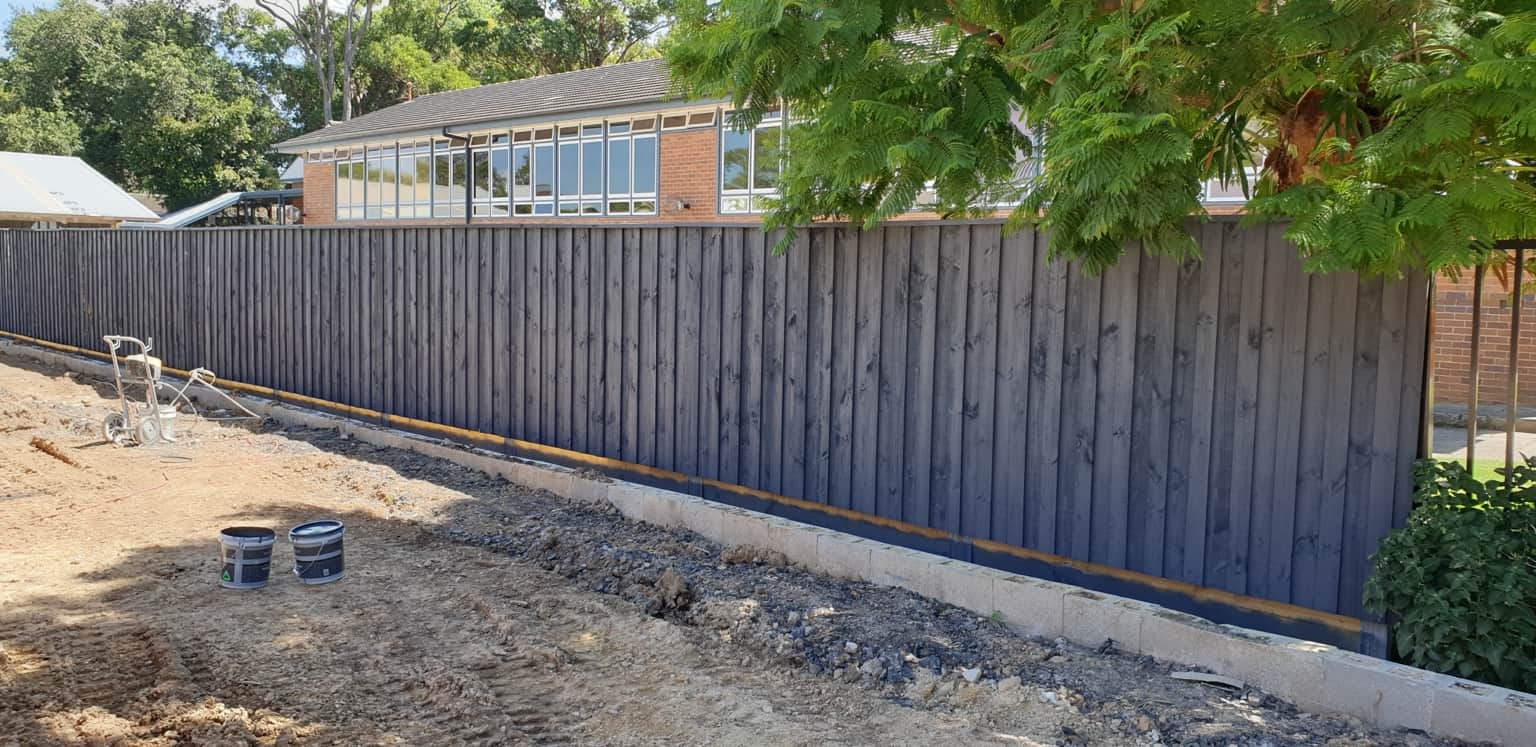 Timber fence painting in progress at Belonging Early Learning, Hornsby