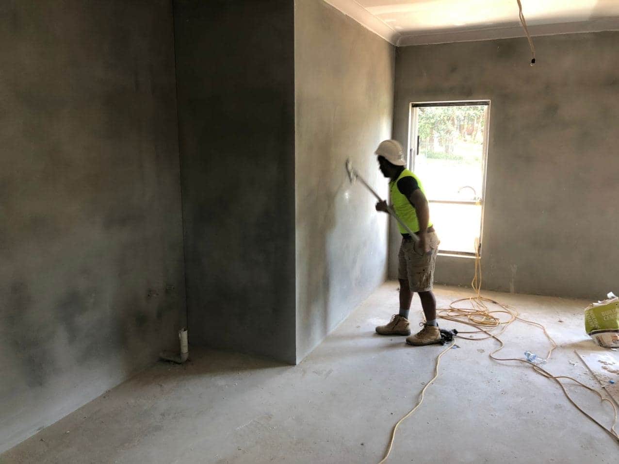 Interior wall painting in progress beside a window in Hornsby