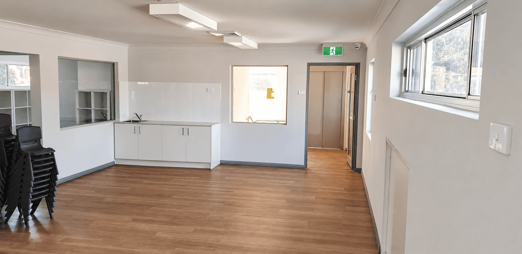 Completed childcare interior with white walls, ceiling and grey door trim in Hornsby