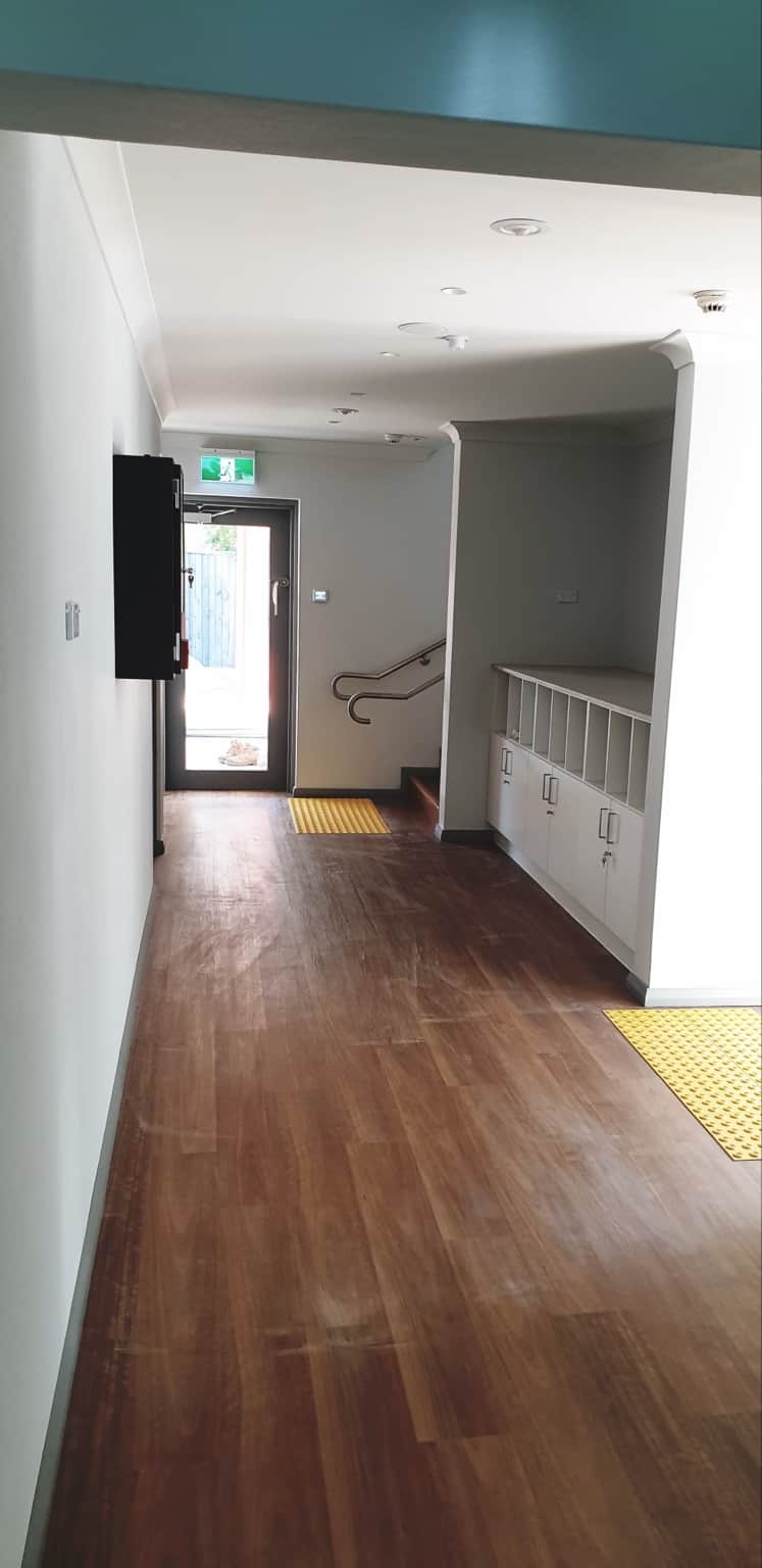 Completed hallway with white walls and grey trim at Belonging Early Learning, Hornsby