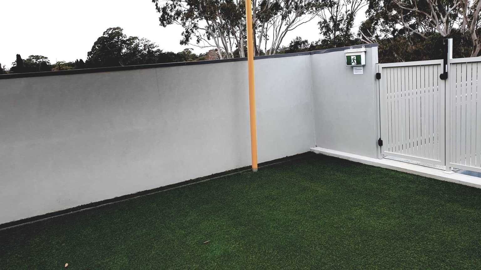 White painted rendered boundary wall and gate at the childcare centre in Hornsby