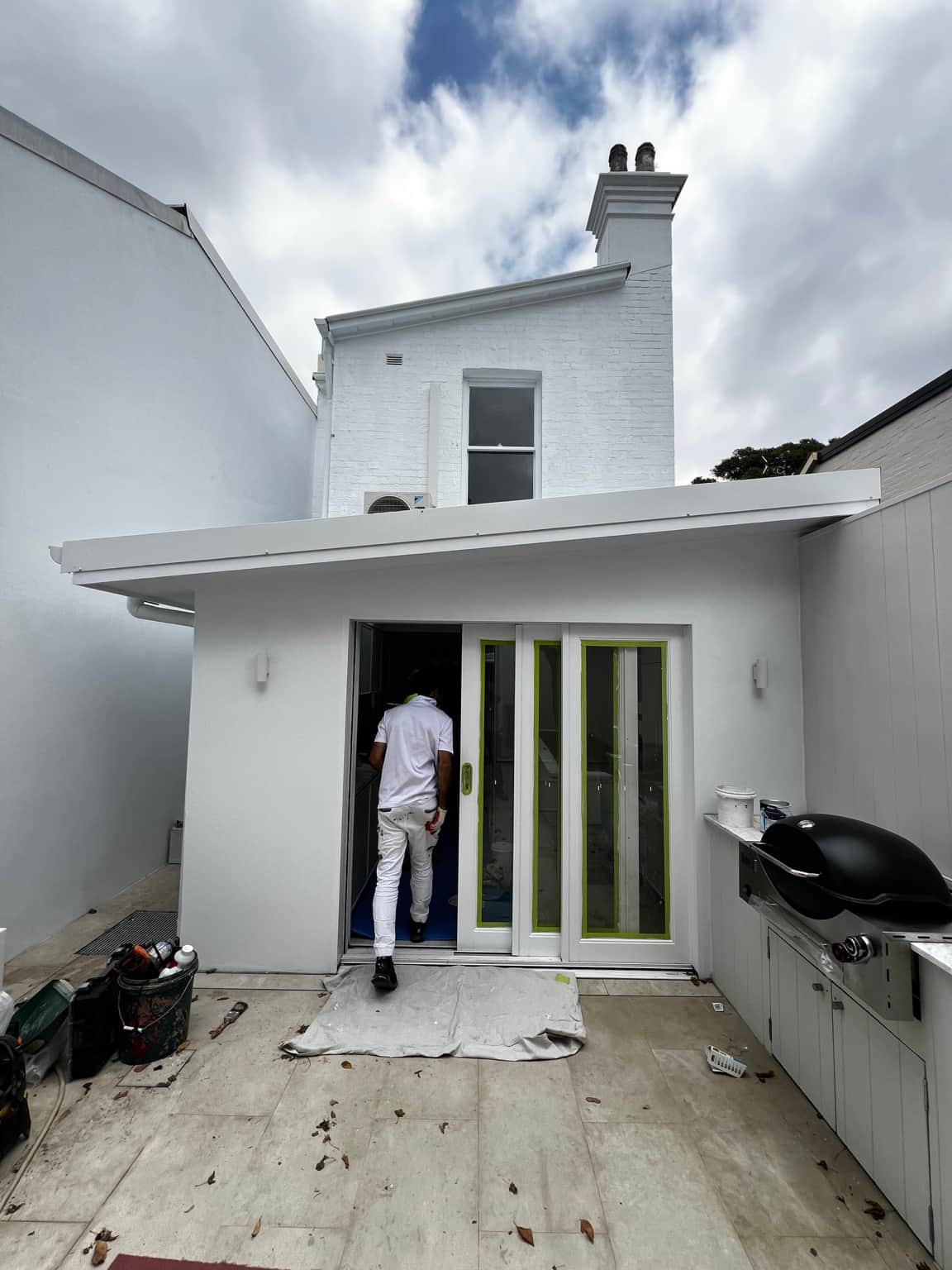 Painting in progress at the rear doorway of the Newtown house
