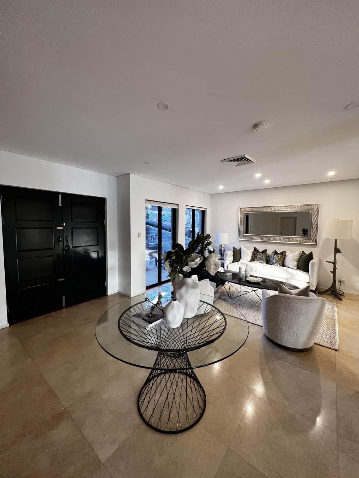 Light interior wall finish beside a black entrance door in a Northbridge home.