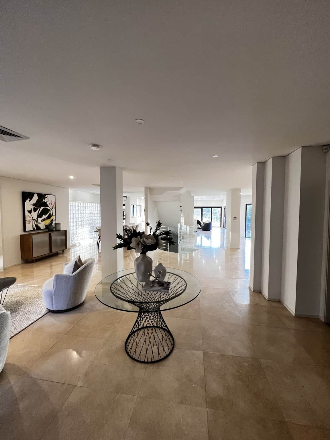 Light walls and ceiling connecting the hallway and living area in a Northbridge home.