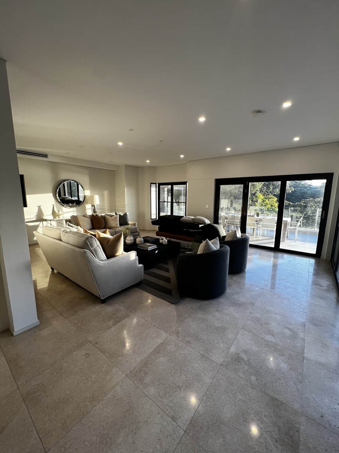 Painted walls and ceiling in a Northbridge open-plan living room with sliding glass doors.